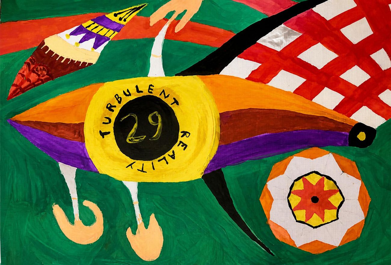 Painting: a colorful bird like form on green with the words turbulent reality circling the number 29 in a yellow disc
